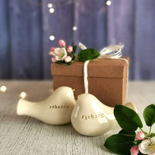 Load image into Gallery viewer, This pair of beautiful wedding cake toppers will add a classy finishing touch to your cake! The elegant cake toppers represent a pair of love birds or white doves. These cake toppers will decorate not only your wedding cake but also your home.