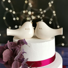 Load image into Gallery viewer, This pair of beautiful wedding cake toppers will add a classy finishing touch to your cake! The elegant cake toppers represent a pair of love birds or white doves. These cake toppers will decorate not only your wedding cake but also your home.