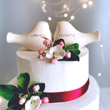 Load image into Gallery viewer, This pair of beautiful wedding cake toppers will add a classy finishing touch to your cake! The elegant cake toppers represent a pair of love birds or white doves. These cake toppers will decorate not only your wedding cake but also your home.