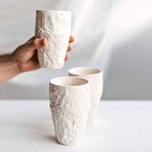 Load image into Gallery viewer, Upgrade your drinkware with these crumpled ceramic tumblers! The tumblers are made from high-quality white clay with a fascinating texture. This ceramic tumbler is perfect for drinking cold beverages like juice, water, milk, soft drinks, and even wine!