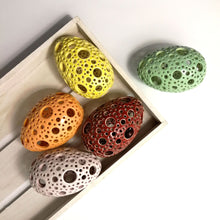 Load image into Gallery viewer, Add all the colors of spring to your home with these gorgeous Easter eggs! These carved ceramic eggs make beautiful spring decorations. Use them as Easter table decor or place them on a shelf or countertop as a springtime accent piece.