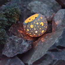 Load image into Gallery viewer, Enjoy this pot as either a planter or a hanging candle holder - the choice is yours! The detailed designs are carved by hand into the pottery and either allow air to circulate to your plant or cast fascinating patterns if you use it as a candle holder!