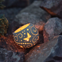Load image into Gallery viewer, Enjoy this pot as either a planter or a hanging candle holder - the choice is yours! The detailed designs are carved by hand into the pottery and either allow air to circulate to your plant or cast fascinating patterns if you use it as a candle holder!