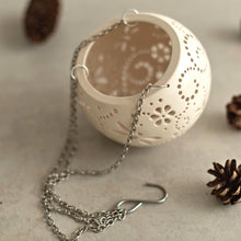 Load image into Gallery viewer, Enjoy this pot as either a planter or a hanging candle holder - the choice is yours! The detailed designs are carved by hand into the pottery and either allow air to circulate to your plant or cast fascinating patterns if you use it as a candle holder!