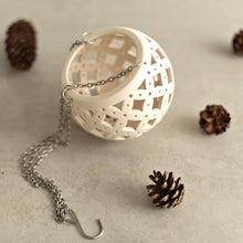 Load image into Gallery viewer, Enjoy this pot as either a planter or a hanging candle holder - the choice is yours! The detailed designs are carved by hand into the pottery and either allow air to circulate to your plant or cast fascinating patterns if you use it as a candle holder!