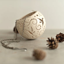 Load image into Gallery viewer, Enjoy this pot as either a planter or a hanging candle holder - the choice is yours! The detailed designs are carved by hand into the pottery and either allow air to circulate to your plant or cast fascinating patterns if you use it as a candle holder!