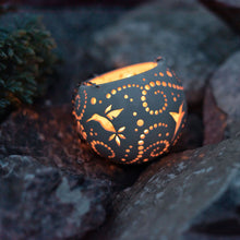 Load image into Gallery viewer, Enjoy this pot as either a planter or a hanging candle holder - the choice is yours! The detailed designs are carved by hand into the pottery and either allow air to circulate to your plant or cast fascinating patterns if you use it as a candle holder!