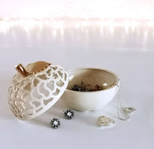 Load image into Gallery viewer, These ceramic bowls with a lid are ideal to use as a vanity jar to keep small valuables safe in the bathroom or bedroom. Ceramic bowls are made from white clay with gold-painted accents and hand-carved cut-outs in the lid.
