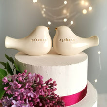 Load image into Gallery viewer, This pair of beautiful wedding cake toppers will add a classy finishing touch to your cake! The elegant cake toppers represent a pair of love birds or white doves. These cake toppers will decorate not only your wedding cake but also your home.
