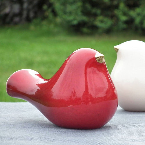 Ceramic bird with a gold beak. This skillfully crafted ceramic bird will look great perched on a shelf, cabinet, or desk. A great statement piece of décor, this ceramic bird will also make a romantic table centerpiece for weddings and other occasions.