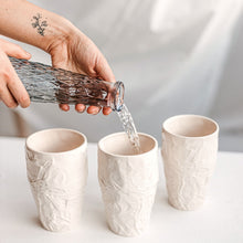 Load image into Gallery viewer, Upgrade your drinkware with these crumpled ceramic tumblers! The tumblers are made from high-quality white clay with a fascinating texture. This ceramic tumbler is perfect for drinking cold beverages like juice, water, milk, soft drinks, and even wine!
