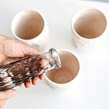 Load image into Gallery viewer, Upgrade your drinkware with these crumpled ceramic tumblers! The tumblers are made from high-quality white clay with a fascinating texture. This ceramic tumbler is perfect for drinking cold beverages like juice, water, milk, soft drinks, and even wine!

