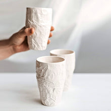 Load image into Gallery viewer, Upgrade your drinkware with these crumpled ceramic tumblers! The tumblers are made from high-quality white clay with a fascinating texture. This ceramic tumbler is perfect for drinking cold beverages like juice, water, milk, soft drinks, and even wine!
