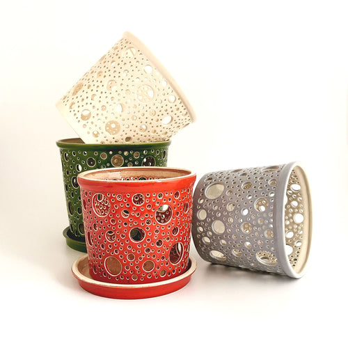 Keep your orchids or other house plants happy in an attractive carved ceramic orchid planter! Each one has carved patterns to allow for aeration of the soil inside the container. You could use this ceramic planter as a fruit bowl or candle holder. 