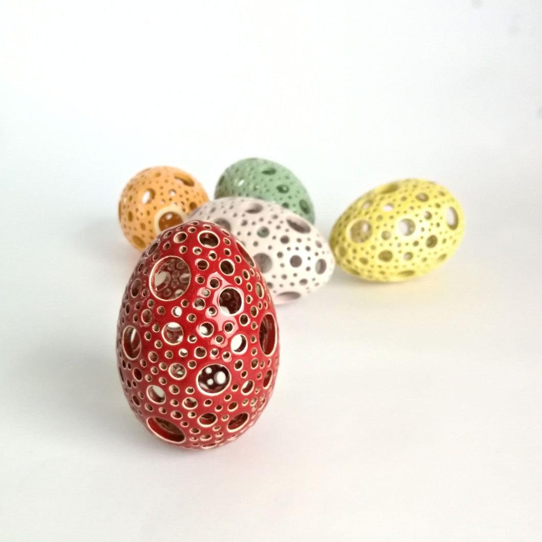 Add all the colors of spring to your home with these gorgeous Easter eggs! These carved ceramic eggs make beautiful spring decorations. Use them as Easter table decor or place them on a shelf or countertop as a springtime accent piece.