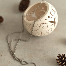 Load image into Gallery viewer, Enjoy this pot as either a planter or a hanging candle holder - the choice is yours! The detailed designs are carved by hand into the pottery and either allow air to circulate to your plant or cast fascinating patterns if you use it as a candle holder!
